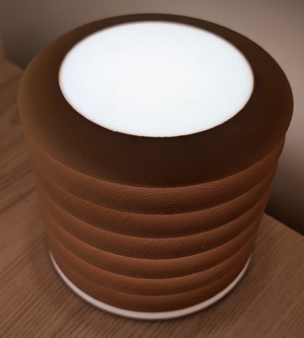 Top view of cylindrical floating lamp with smooth white diffuser and stacked ring illusion