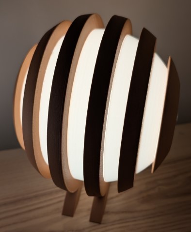 Three-quarter view of the Originless Glow lamp revealing layered symmetry and structure depth.
