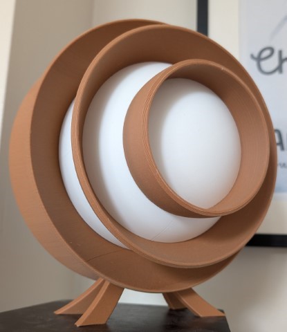3D printed Spin Light showing layered circular structure in daylight, unlit.