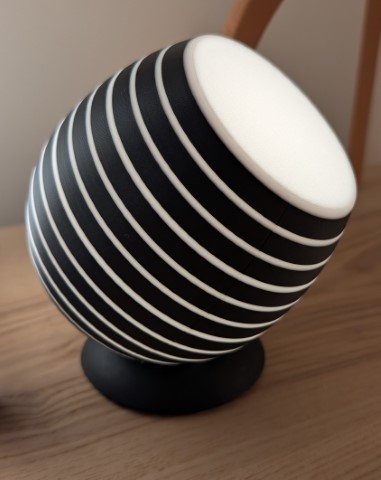 Spotlight with horizontal light rings, angled as if it’s making a break for freedom.