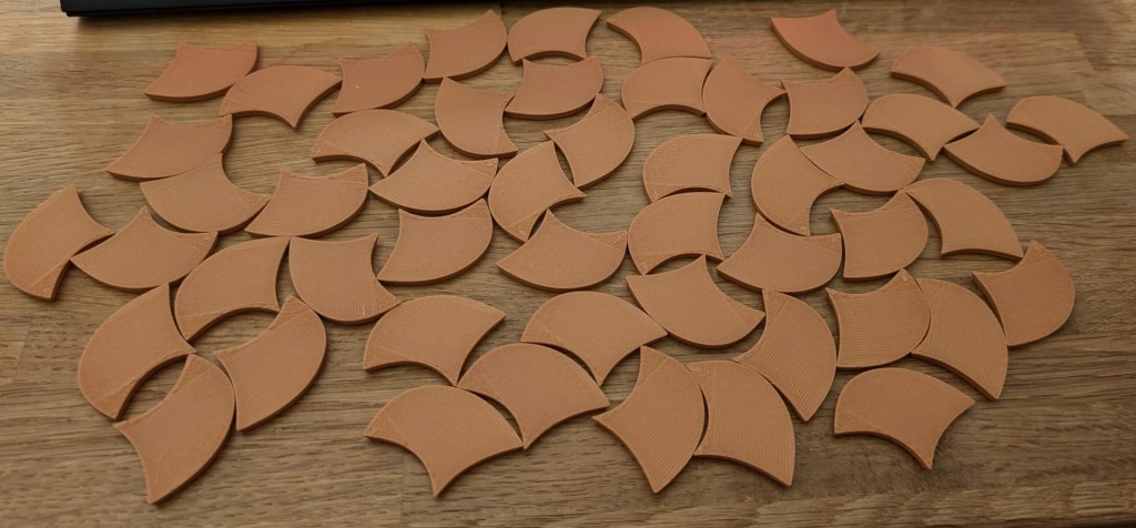 3D printed Penrose tiles, showing the front, looking like snackable nachos.